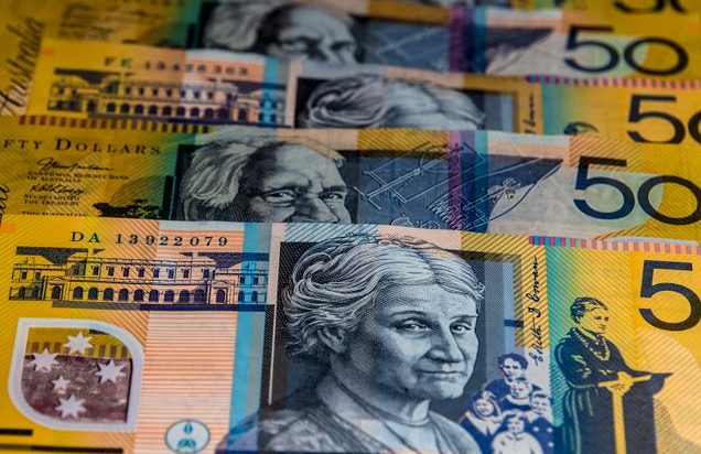 Close-up view of Australian $50 bills arranged in a pattern. Vibrant colors and detailed imagery highlight currency features.